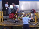 How many people does it take to unload our bicycles from the train ride  between Prince George and Jasper?